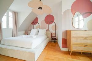 - une chambre avec un lit blanc et des murs rouges et blancs dans l'établissement Appartement Haussmannien 16ème arrondissement, à Paris