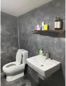 a bathroom with a white toilet and a sink at Royal mountain view (วิวเขาหลวง) in Ratchaburi