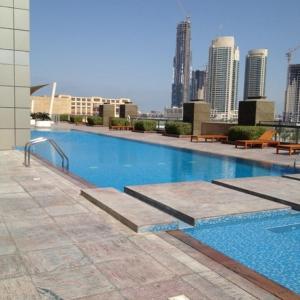 a large swimming pool on top of a building at Nasma Luxury Stays - Charming And Fancy Studio In The Heart of Dubai in Dubai
