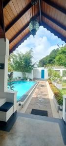 a view of a swimming pool from the patio of a house at Kaya Residence Kandy in Kandy