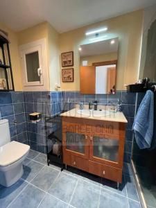 a bathroom with a toilet and a sink and a mirror at BV-ST-010-Apartamento Can Villa in San Pol de Mar