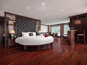 a bedroom with a large bed and a dining room at Erina Cruise in Ha Long