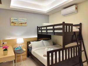 a bedroom with two bunk beds and a desk at TopGenting RedMarbleColdSty2R2B7Pax at GrdIonDelmn in Genting Highlands