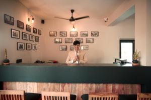 a man standing behind a bar in a restaurant at Clarks Safari Pushkar in Pushkar