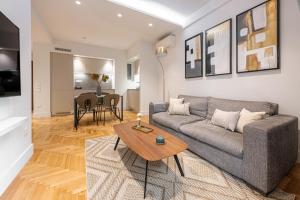 ein Wohnzimmer mit einem Sofa und einem Tisch in der Unterkunft Phaedrus Living: Executive Flat Kolonaki in Athen