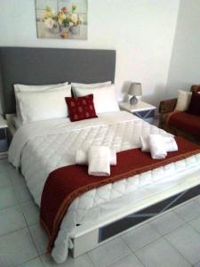 a bedroom with a large white bed with towels on it at Studio Marina in Sivas beautiful Village in Sívas