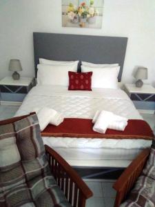 a bedroom with a large white bed with red pillows at Studio Marina in Sivas beautiful Village in Sívas