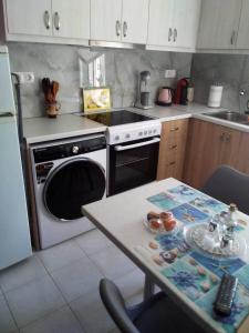 a kitchen with a stove and a table in it at Studio Marina in Sivas beautiful Village in Sívas