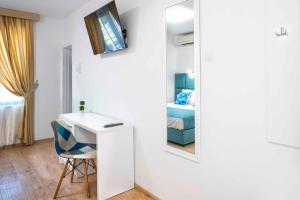 a room with a desk and a bedroom with a bed at Електра Апарт Бургас Electra Apart Burgas Elektra Bourgas in Burgas