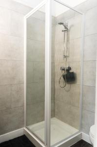 a shower with a glass door in a bathroom at The Lakeside in Redcar +7 photos
