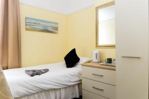 a small bedroom with a bed and a window at The Lakeside in Redcar