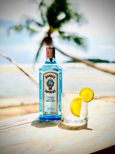 a bottle of gin sitting on a table next to a drink at Jayden Villas in Hinkong