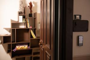 an open door to a room with a book shelf at San Nicolicchio - Luxury Guest House in Taranto +20 photos