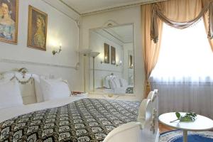 a bedroom with a large bed and a large mirror at Queen's Astoria Design Hotel in Belgrade +33 photos