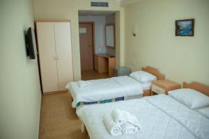 Postel nebo postele na pokoji v ubytování Hotel Oaz
