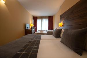 Postel nebo postele na pokoji v ubytování Hotel Màgic Ski