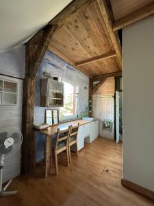 a kitchen with a table and chairs in a room at Domek przy plaży in Rewa