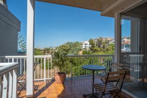 a balcony with a table and chairs and a view at Casa Cala Balmins in Sitges