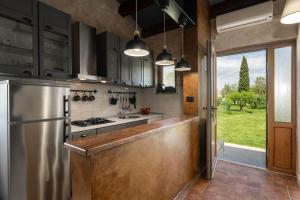 a kitchen with a stainless steel refrigerator and a stove at Apartman Ela Vi in Kršan