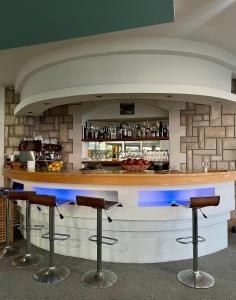 a bar with stools in front of a brick wall at Apartments Amina in Ulcinj