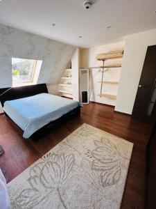 a bedroom with a bed and a rug at Svetes house - Garden & BBQ & Parking in Liepāja