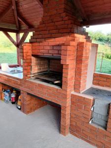 an outdoor brick oven with a sink on a patio at Casa Alex in Topliţa