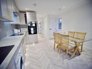 a kitchen and dining room with a table and chairs at Ideal Lodgings in Radcliffe in Radcliffe