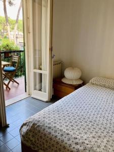 a bedroom with a bed and a door to a balcony at La Casetta in Portovenere