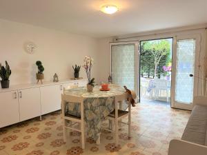 a kitchen with a table with a table cloth on it at Villa Luisa in Lignano Sabbiadoro