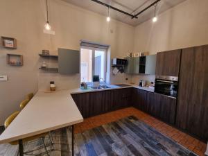a large kitchen with a table in a room at Villa Pintucci in Trani