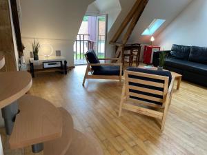 a living room with a couch and a table and chairs at La Ferme de Wolphus in Zouafques