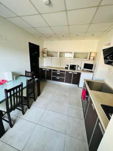 a kitchen with a table and chairs and a dining room at Svetes house - Garden & BBQ & Parking in Liepāja