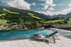 a pool on the roof of a house with a chair at Apartmentresort MyLodge in Schladming