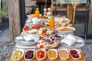 a table topped with plates of food on top at Dmira Alacati in Alaçatı