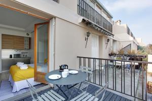 パリにあるPick A Flat's Apartment in Madeleine - Boulevard de la Madeleineのバルコニー(テーブル、椅子付)、ベッドルーム1室が備わります。