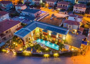 an aerial view of a house with a pool at night at Dmira Alacati in Alaçatı