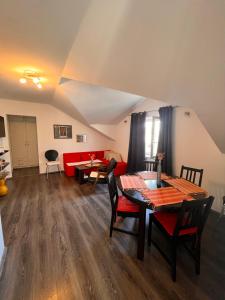 a living room with a table and a red couch at Apartment Antonia in Vrboska