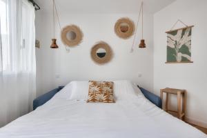 a bedroom with a bed with a pillow on it at Studio avec terrasse à 250 mètres du port in Rivedoux-Plage