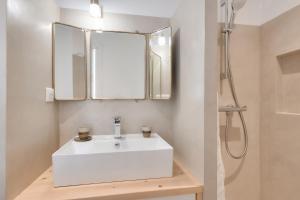 a bathroom with a white sink and a mirror at Studio avec terrasse à 250 mètres du port in Rivedoux-Plage +9 photos