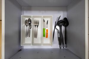 a drawer filled with utensils in a white cabinet at marron studios 4 new in Cairo