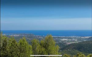 a view of the ocean from the top of a hill at Stramousse in Cabris