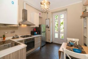 a kitchen with a sink and a stove top oven at Exploring Turin: Crocetta Mini Flat in Turin