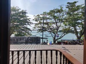 a balcony with a view of the water and a pier at Horizon Inn in Kampung Teluk Nipah