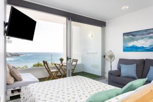a bedroom with a bed and a view of the ocean at Front beach studio in Callao Salvaje