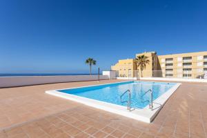 a swimming pool in the middle of a building at Front beach studio in Callao Salvaje