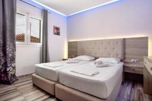 Postel nebo postele na pokoji v ubytování Villa Dionysia Apartment A1 + 22 fotografií