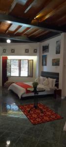 a large bedroom with a bed and a rug at Valhalla Bed & Breakfast in Salatiga