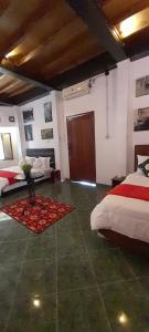 a bedroom with two beds and a door in it at Valhalla Bed & Breakfast in Salatiga