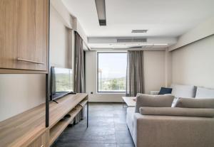 A television and/or entertainment centre at Serenity Suites Sea View Houses