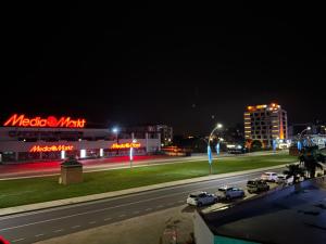 a city street at night with cars on the road at Vera Suite Hotel Trabzon in Trabzon